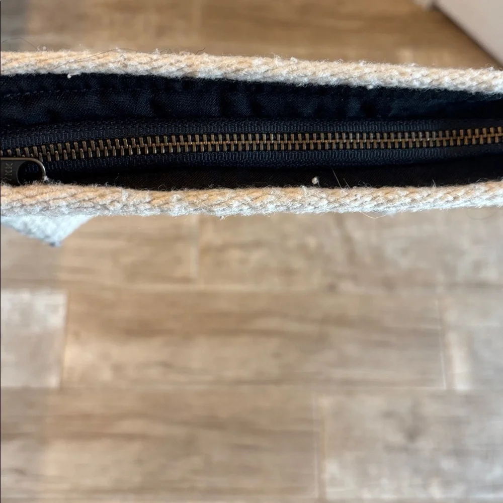 Handmade, one of a kind hundred percent wool clutch with leather wrist band.
